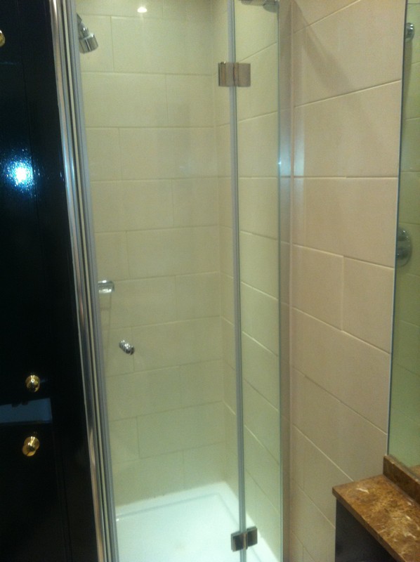 Frameless glass shower enclosure with chrome fittings in Croydon